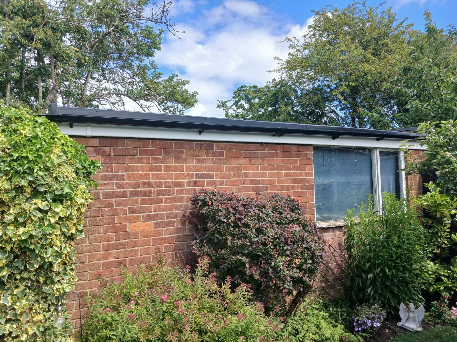 Finished flat roof with new fascia and black drip trim