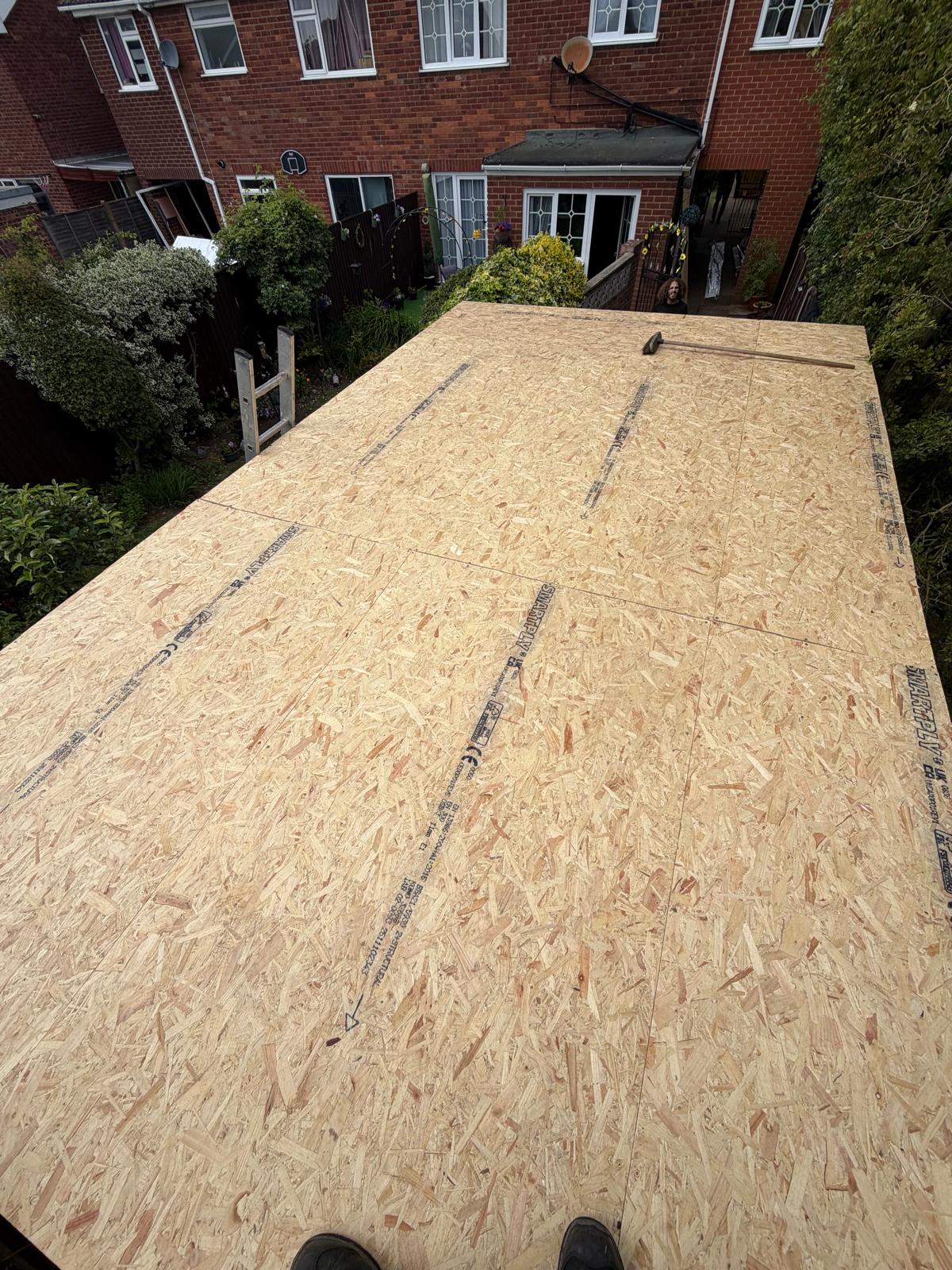 Flat roof deck rebuilt with new OSB boards ready for EPDM